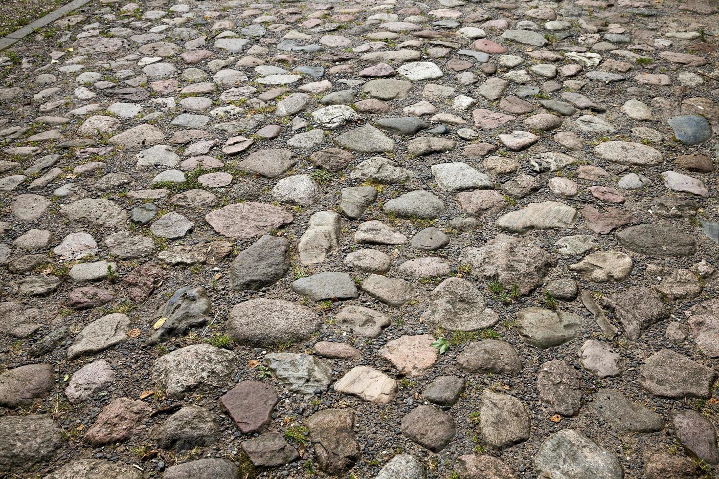 the old road is made of stones and cobblestones photo