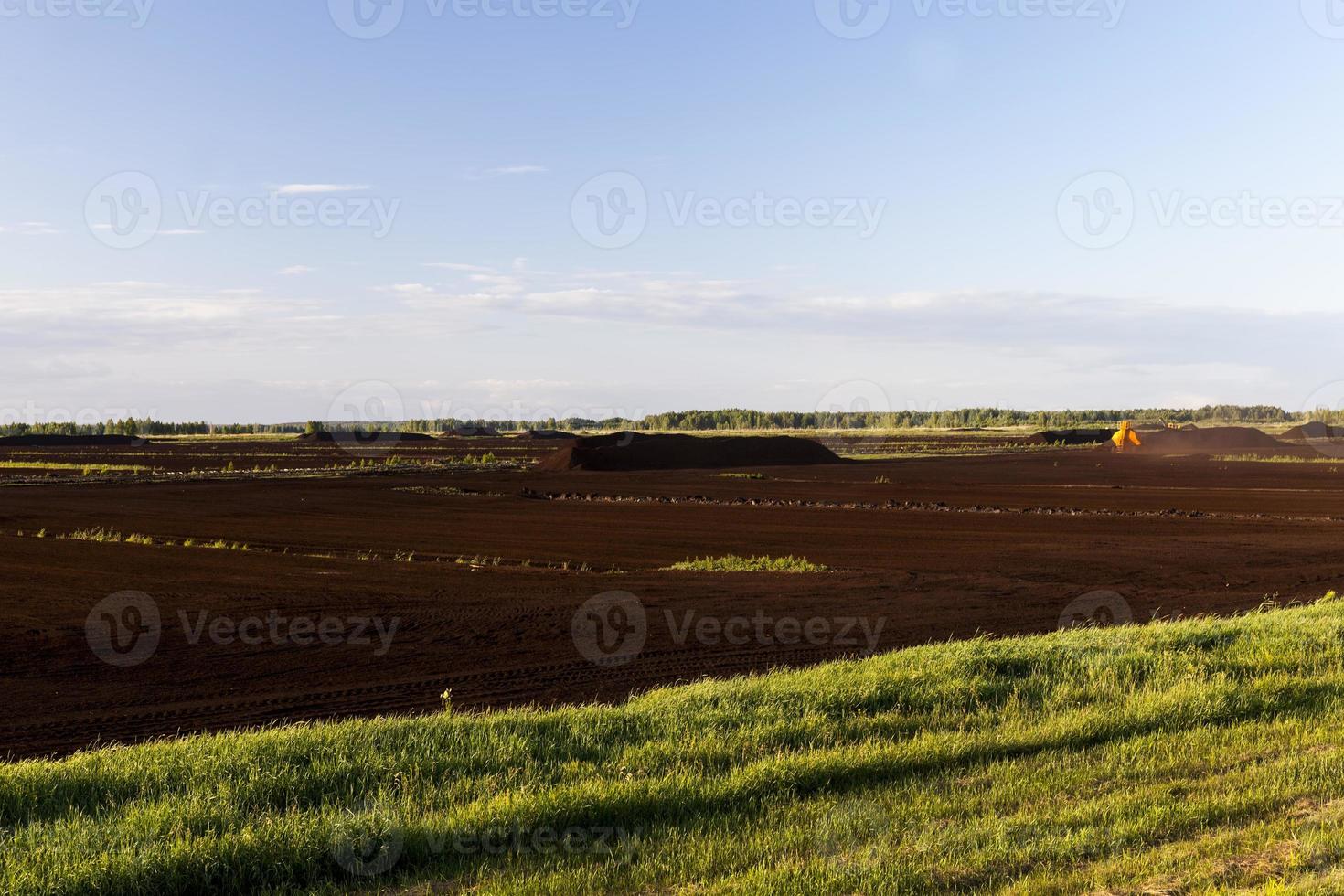 black peat dumped in heaps during its extraction photo