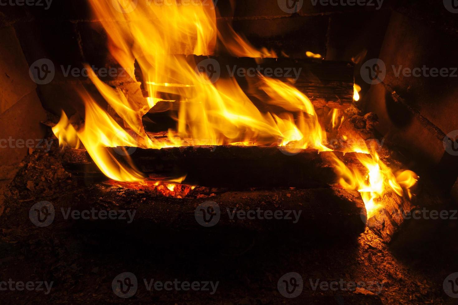 burning logs in the fire of a barbecue or stove or fireplace photo