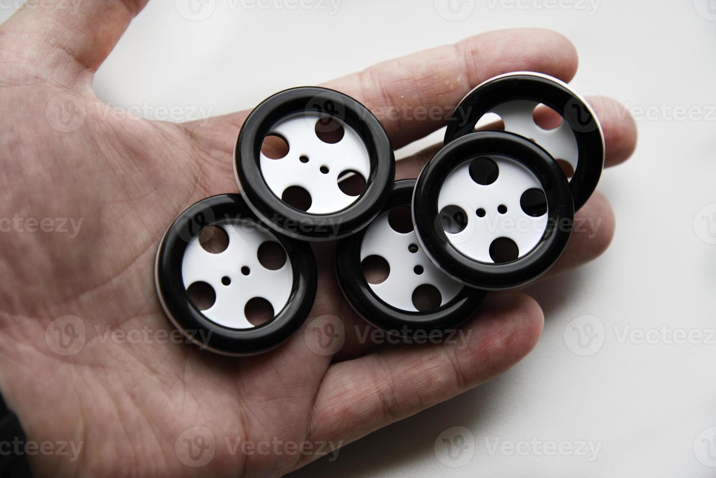 Large black and white buttons with clothes in hand. photo