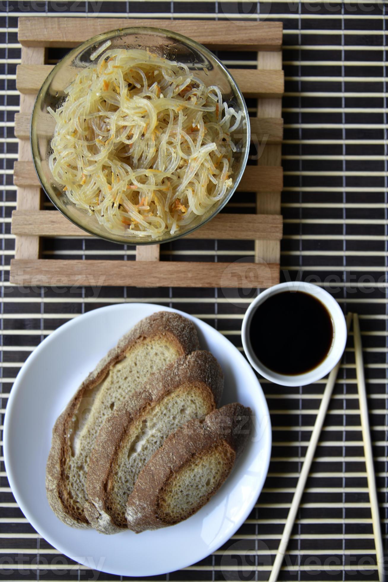 Korean rice noodles with meat and spices. Noodles with sauce and bread