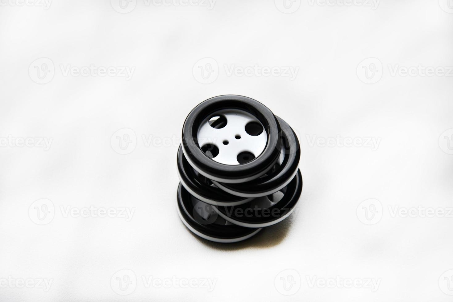 Large black and white buttons with clothes on a white background photo