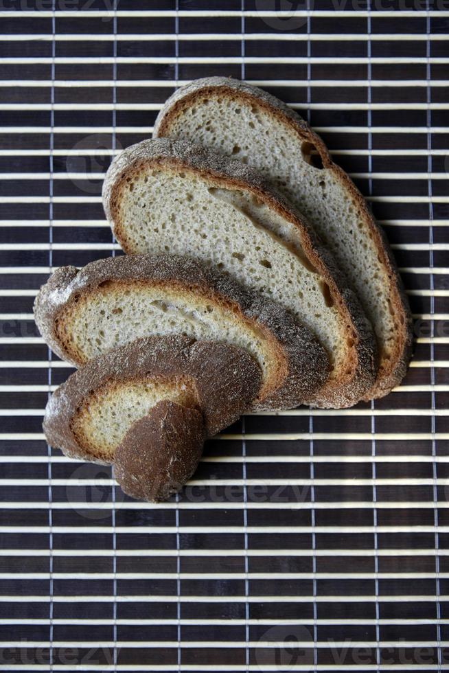 Sliced rye delicious bread on a mat. Lunch bread close-up. photo