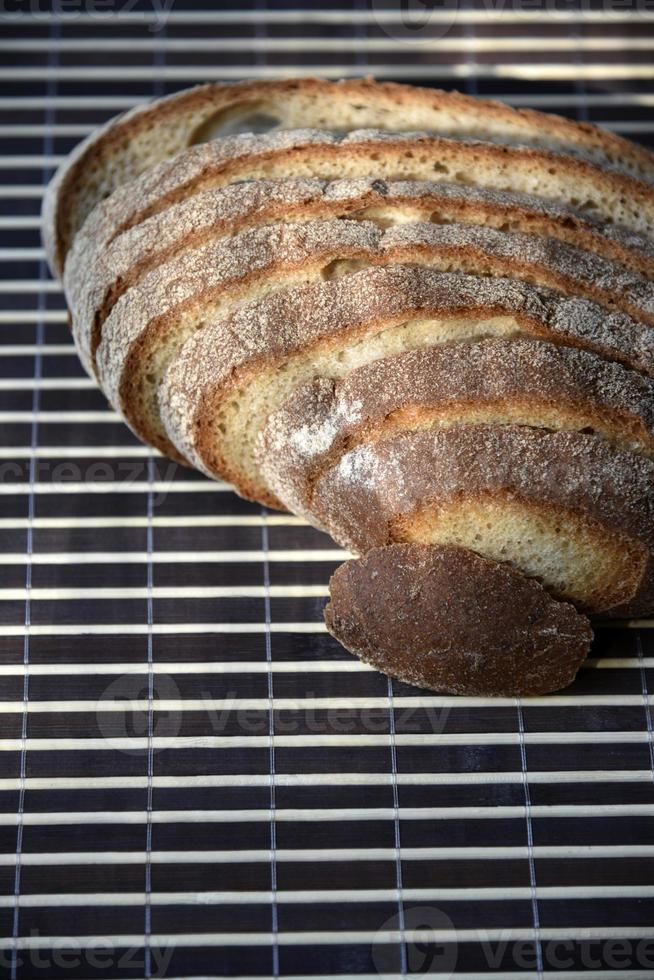 Sliced rye delicious bread on a mat. Lunch bread close-up. photo