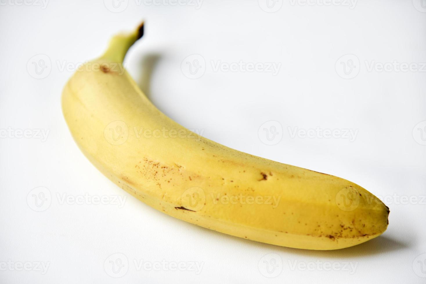 Ripe yellow banana on a white background. A bunch of fresh bananas. Sweet bananas for breakfast. photo