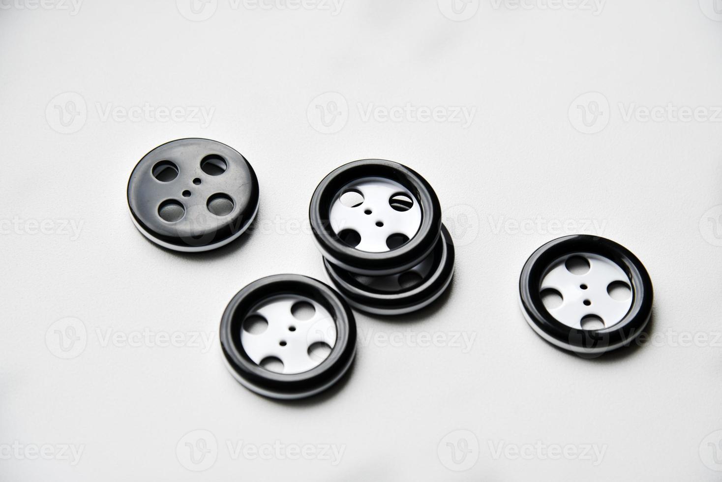 Large black and white buttons with clothes on a white background photo
