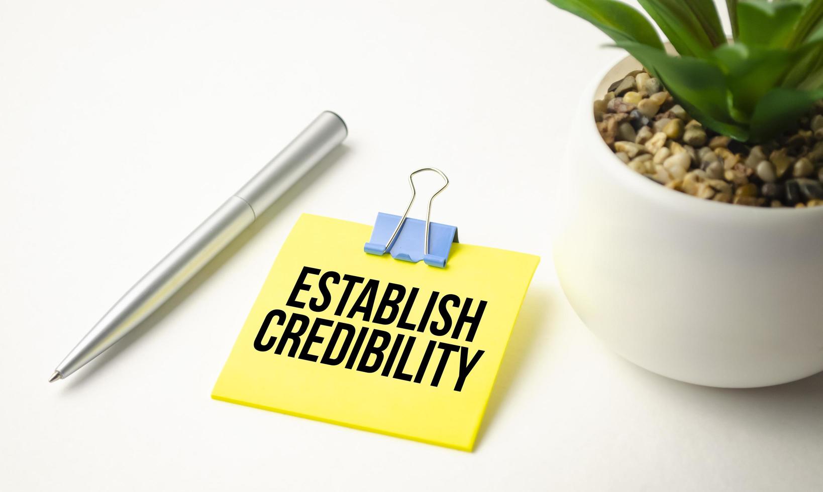 yellow paper with the text ESTABLISH CREDIBILITY photo