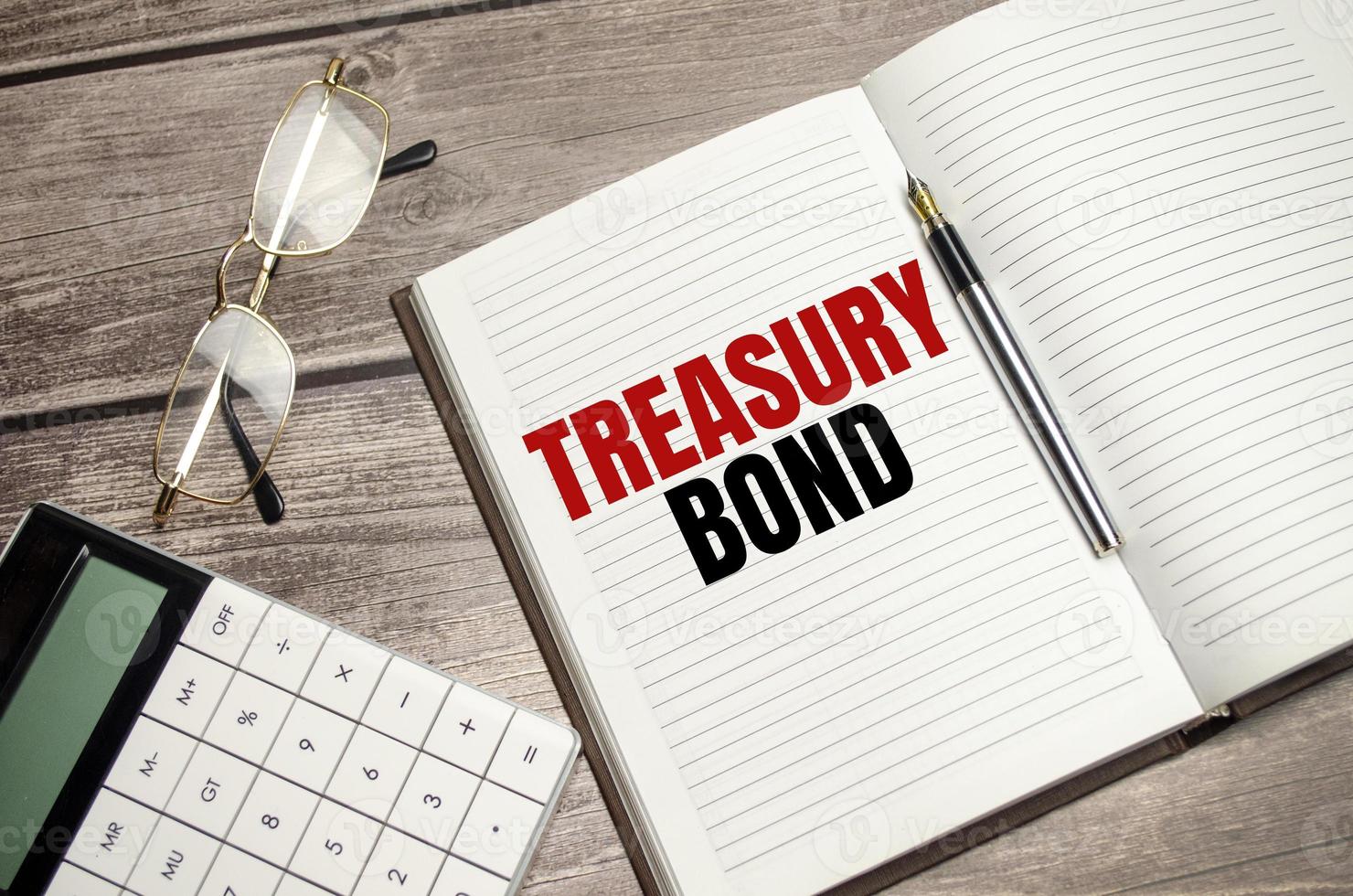 Treasury bond text on a notepad with pen, business photo