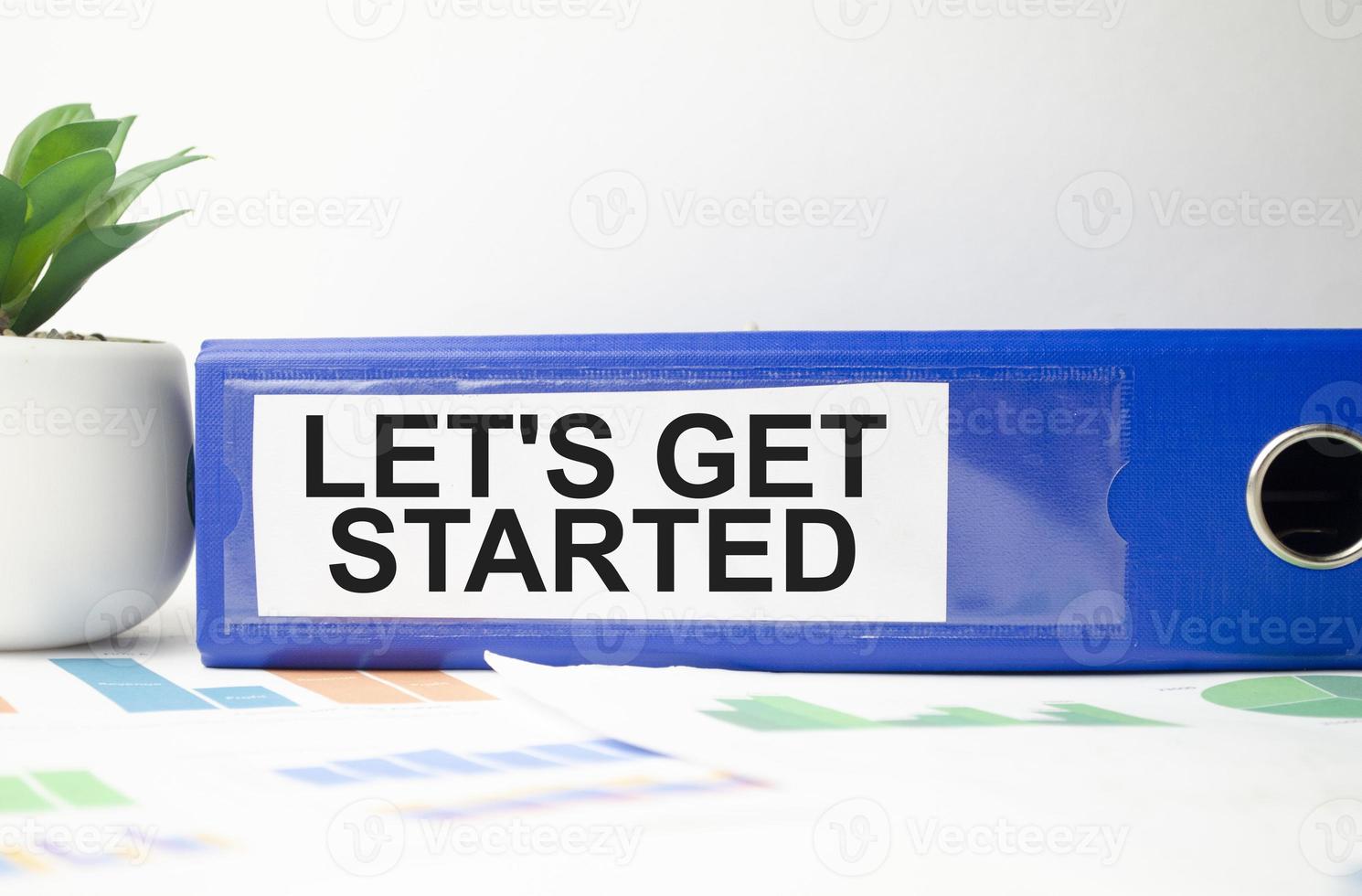 LET'S GET STARTED text concept write on file folder with office tools photo