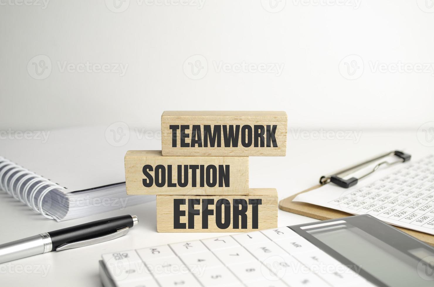 words written on a wooden block, teamwork, solution, effort and office supplies photo