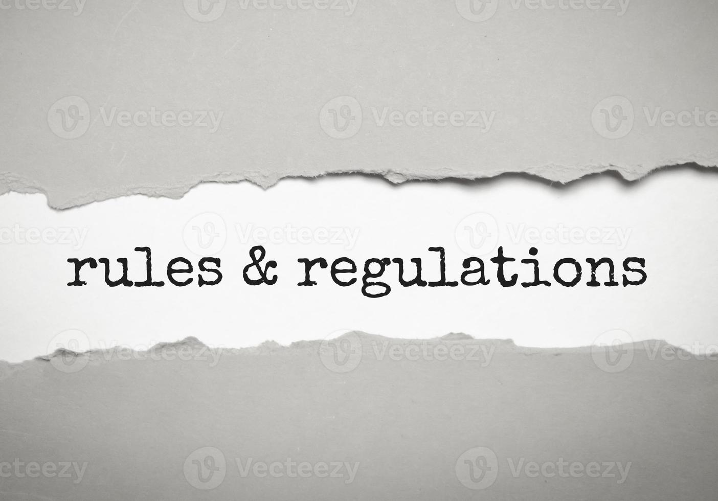 rules and regulations word under torn grey paper photo