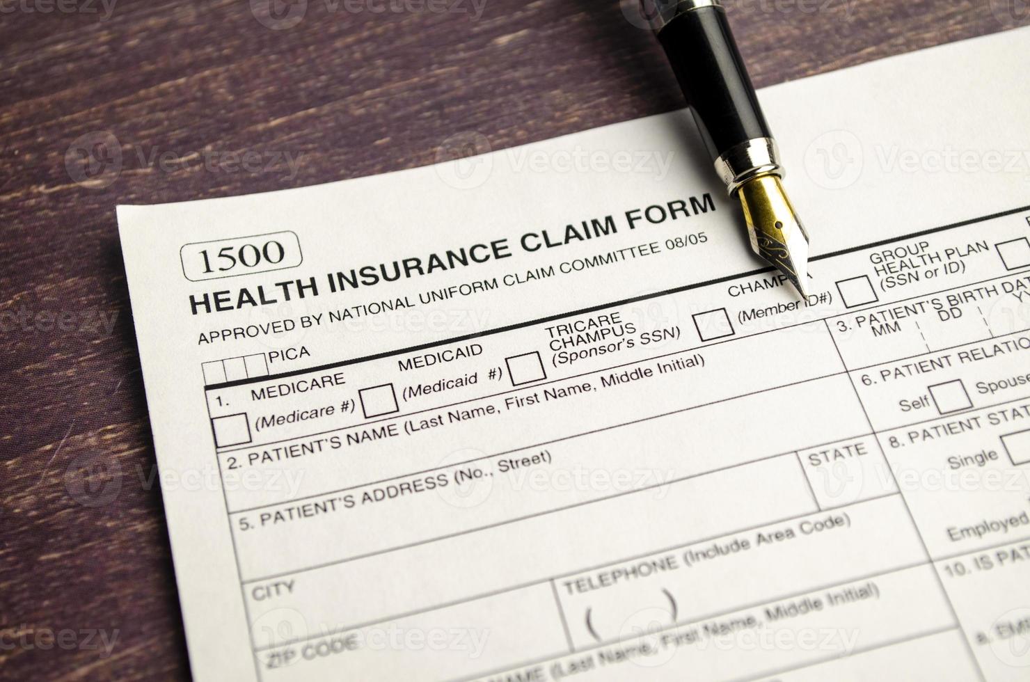 health insurance form with pen on wooden background photo