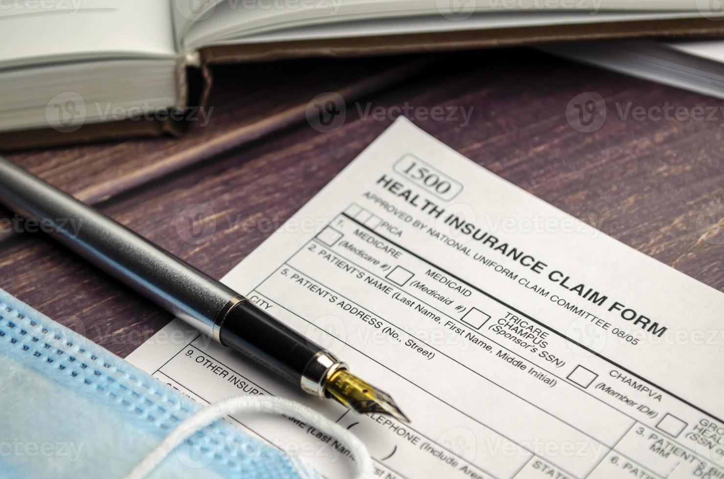 health insurance form with pen on wooden background photo