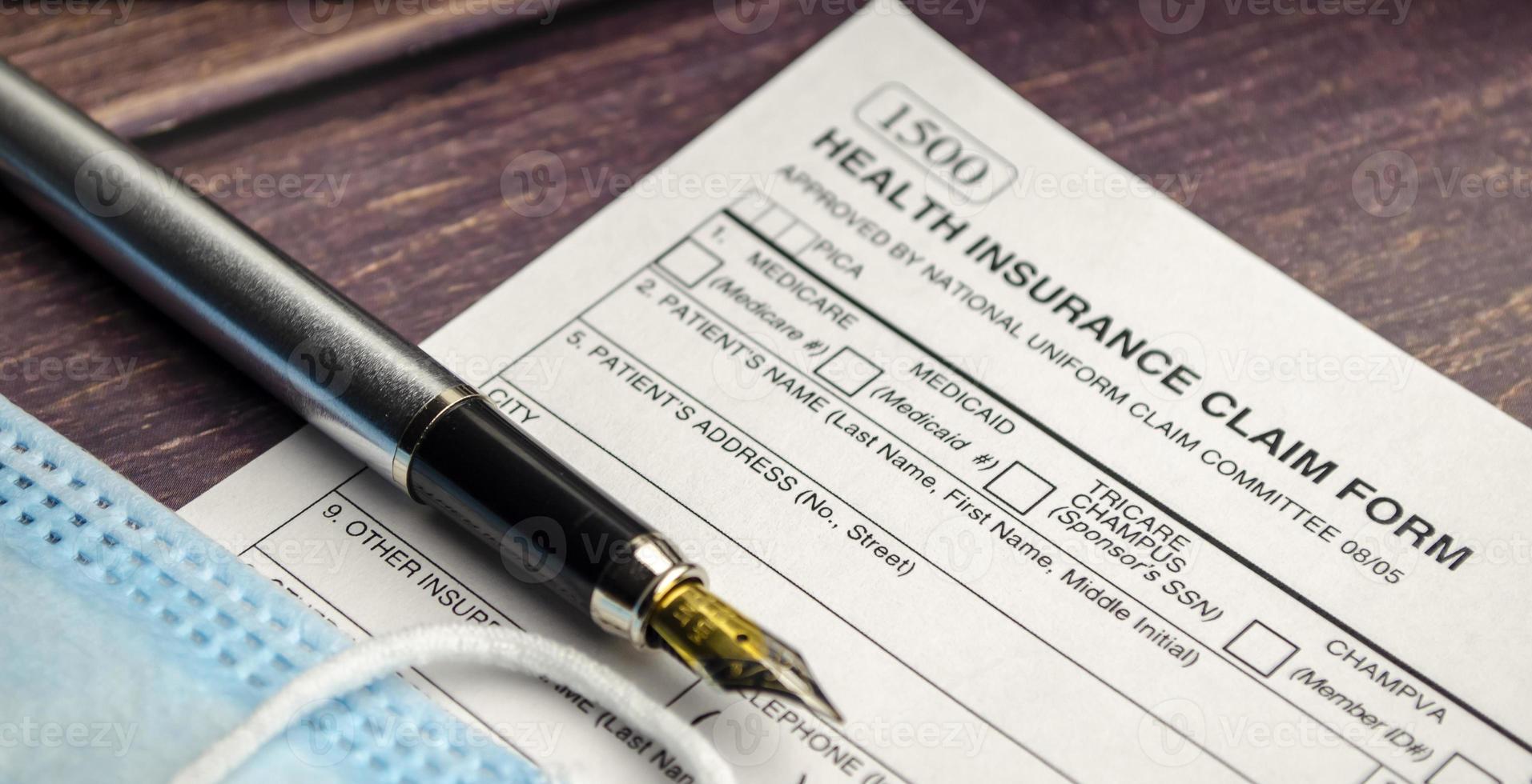 health insurance form with pen on wooden background photo