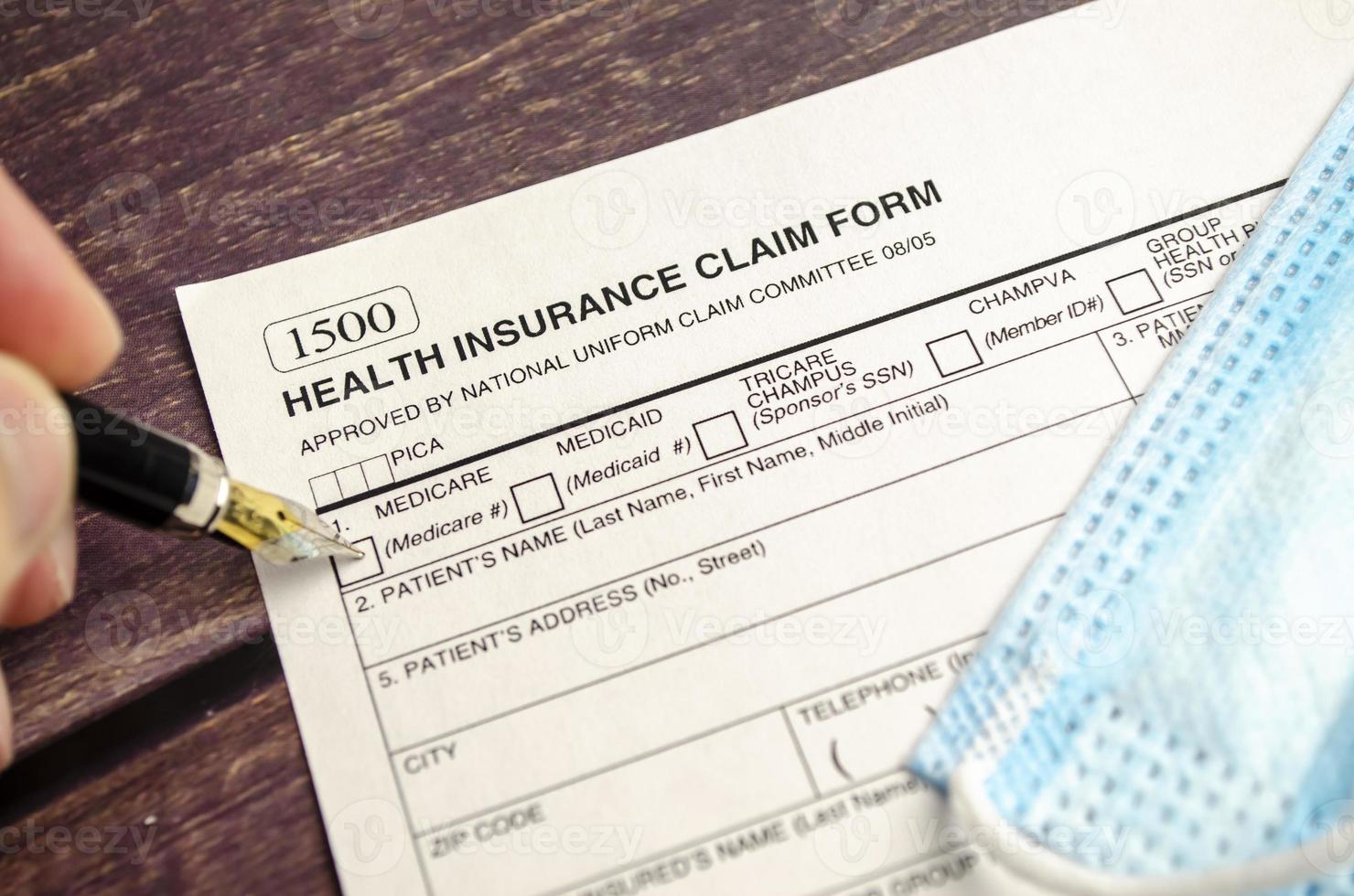 health insurance form with pen on wooden background photo