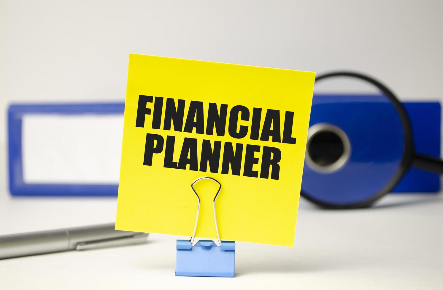 FINANCIAL PLANNER text on yellow sticker and file folder photo