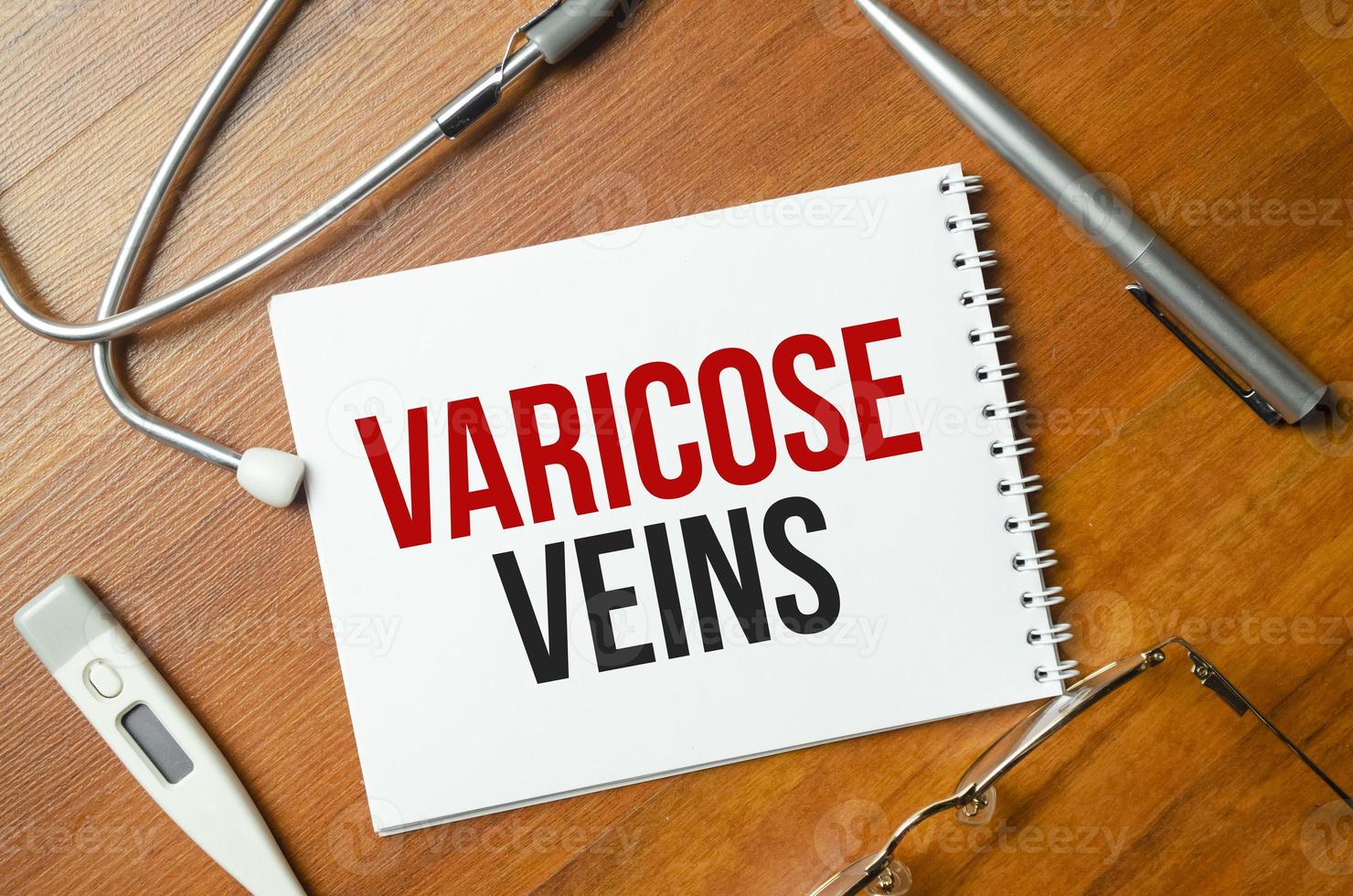 The word VARICOSE is written on a white sheet near the stethoscope photo