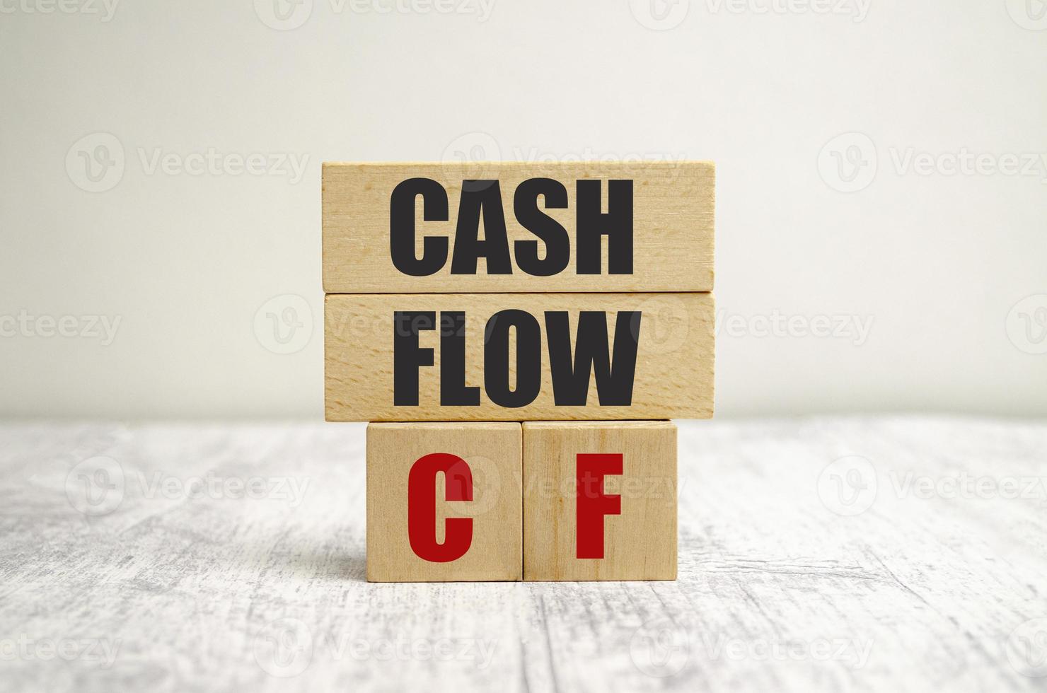 Text cash flow on wooden blocks on wooden background photo