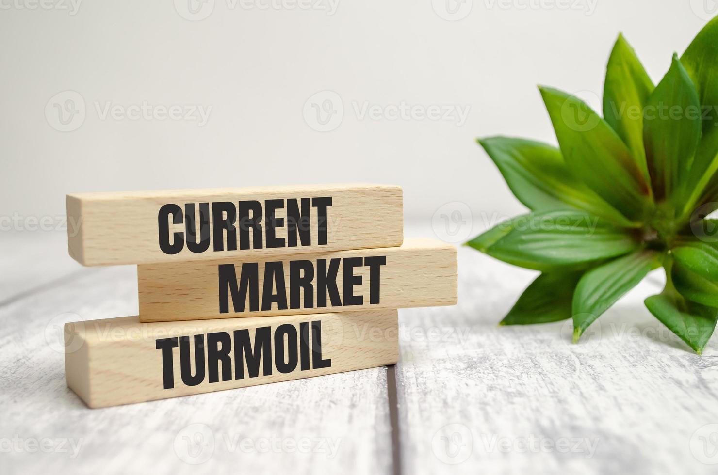 Current market turmoil on wooden blocks on a beautiful white table photo