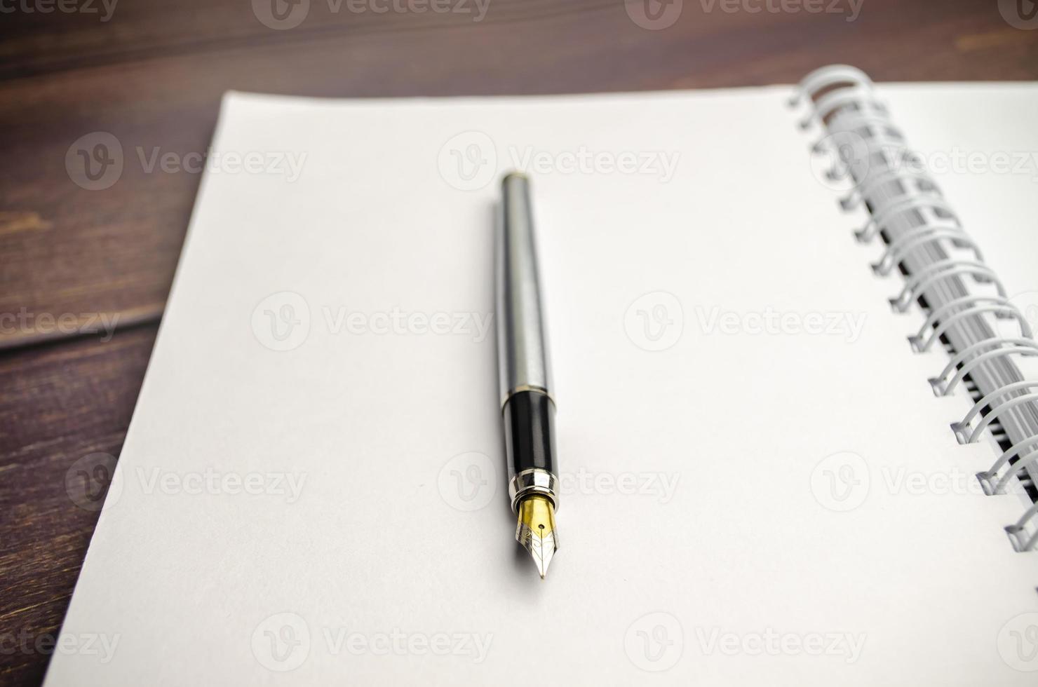 fountain pen near the notepad on the desktop 9693435 Stock Photo at