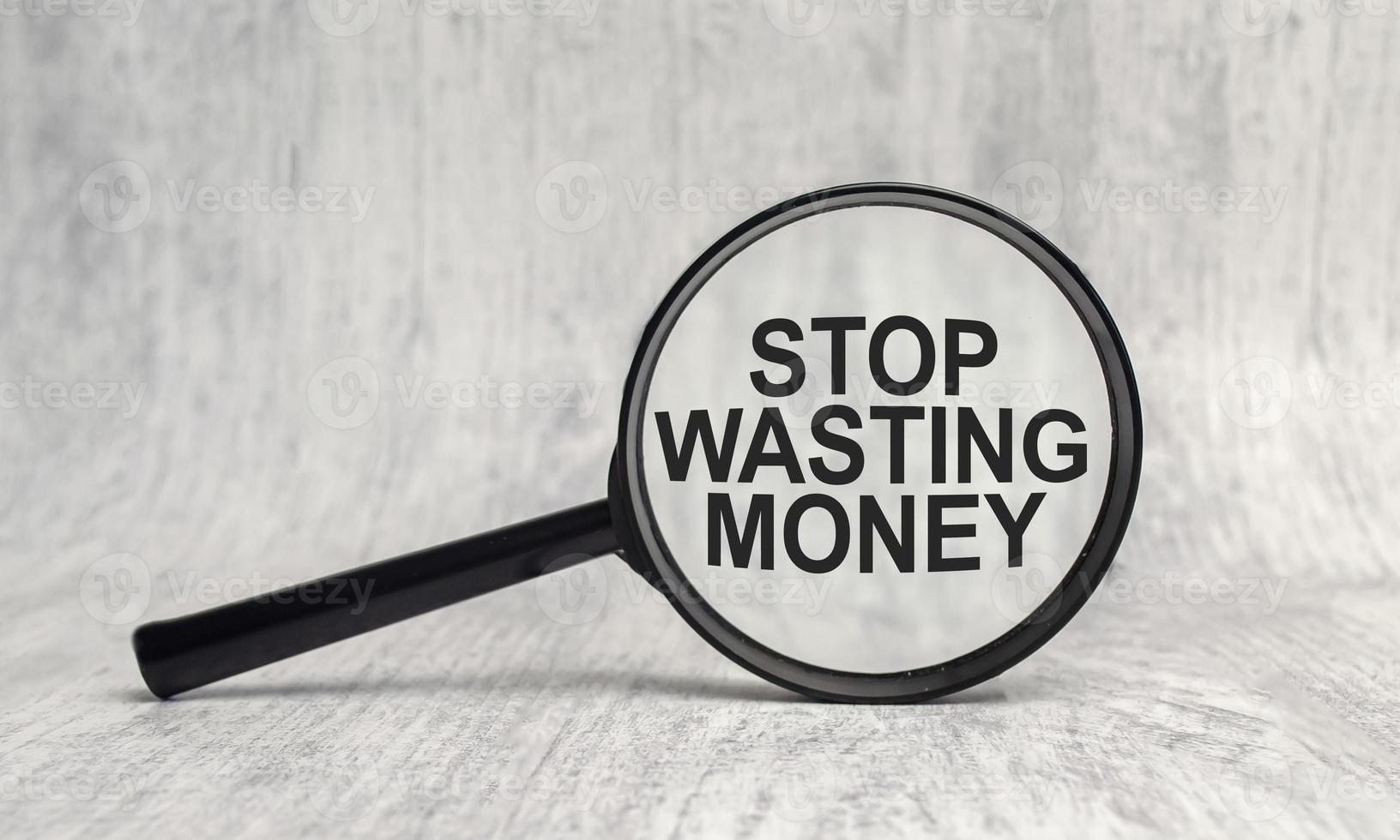 Stop wasting money word through a magnifying glass photo