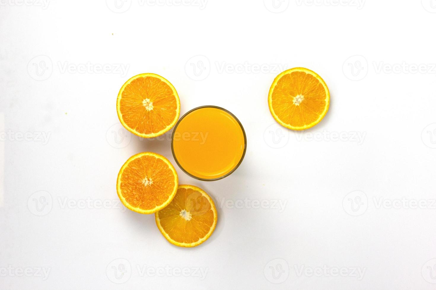 juicy oranges pieces with glass isolated on white background, top view concept photo