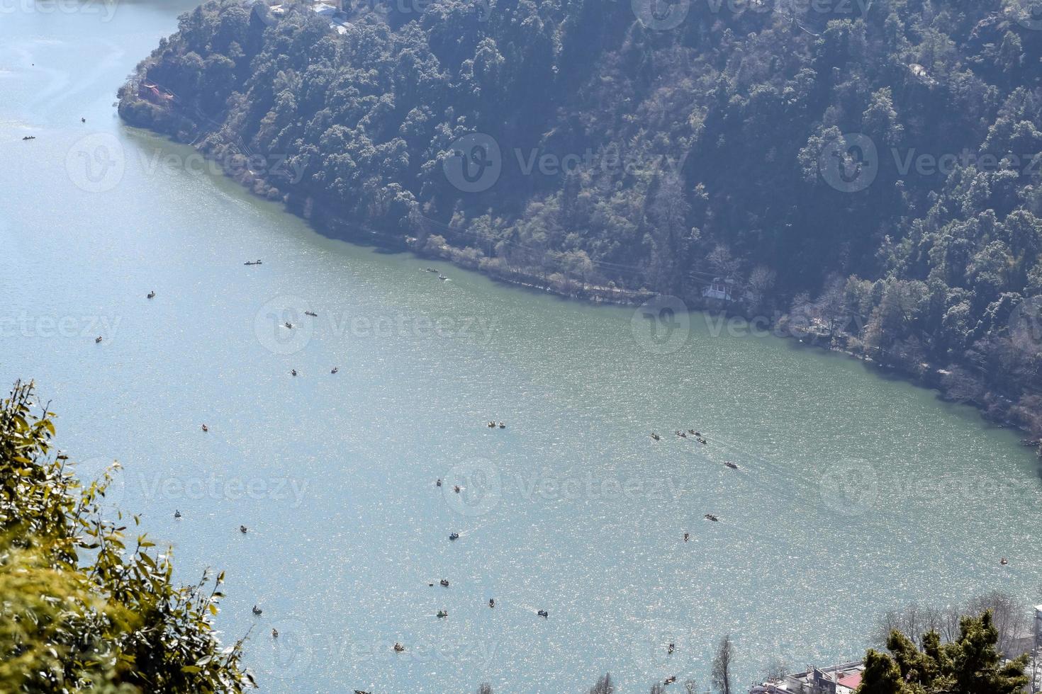 Full view of Naini Lake during evening time near Mall Road in Nainital, Uttarakhand, India, Beautiful view of Nainital Lake with mountains and blue sky photo