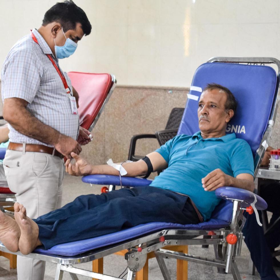 Delhi, India, June 19 2022 - Blood donor at Blood donation camp held at Balaji Temple, Vivek Vihar, Delhi, India, Image for World blood donor day on June 14 every year, Blood Donation Camp at Temple photo