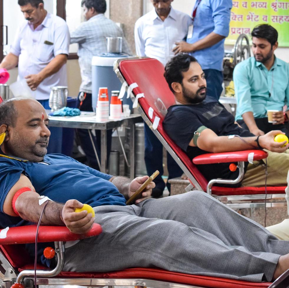 Delhi, India, June 19 2022 - Blood donor at Blood donation camp held at Balaji Temple, Vivek Vihar, Delhi, India, Image for World blood donor day on June 14 every year, Blood Donation Camp at Temple photo