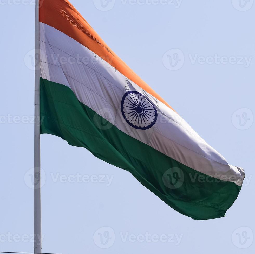 India flag flying high at Connaught Place with pride in blue sky, India flag fluttering, Indian Flag on Independence Day and Republic Day of India, tilt up shot, waving Indian flag, Flying India flags photo