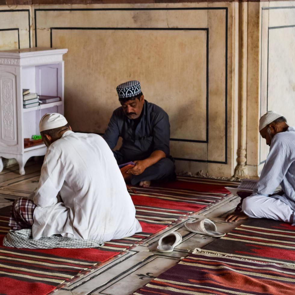 Delhi, India - April 15, 2022 - Unidentified Indian tourists visiting Jama Masjid during Ramzan season, in Delhi 6, India. Jama Masjid is the largest and perhaps the most magnificent mosque in India photo