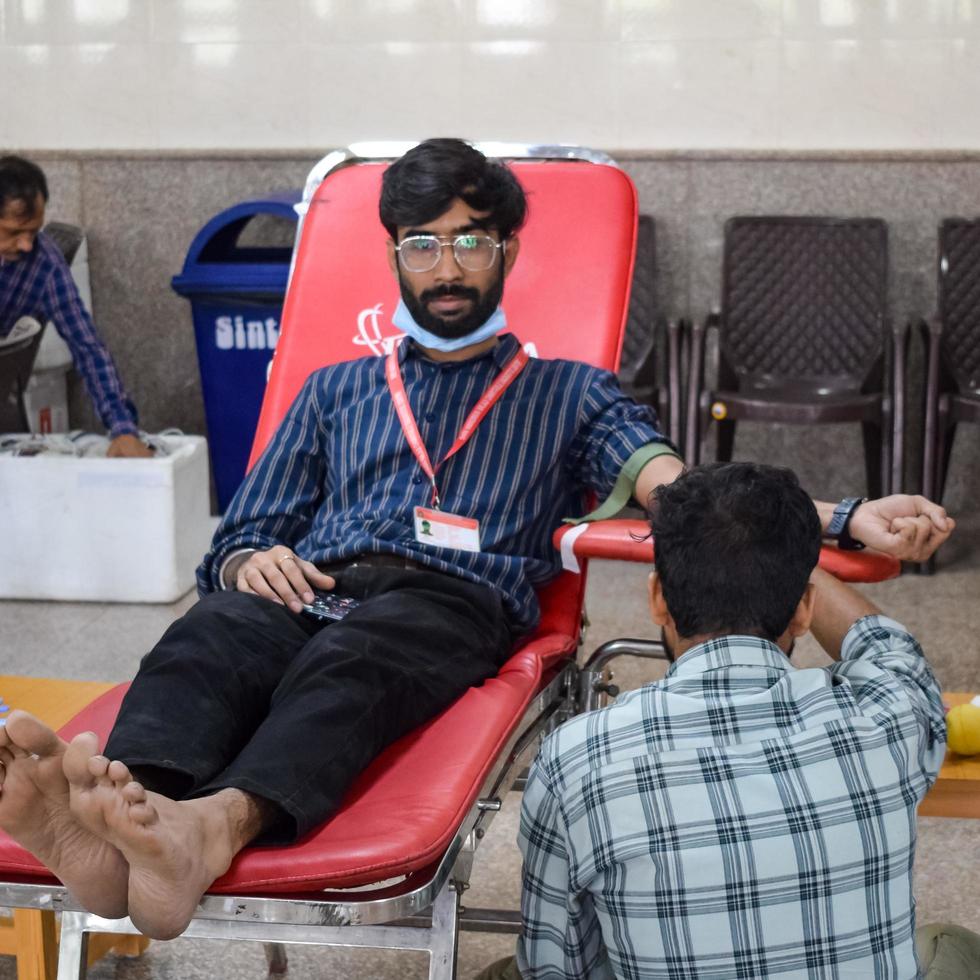 Delhi, India, June 19 2022 - Blood donor at Blood donation camp held at Balaji Temple, Vivek Vihar, Delhi, India, Image for World blood donor day on June 14 every year, Blood Donation Camp at Temple photo