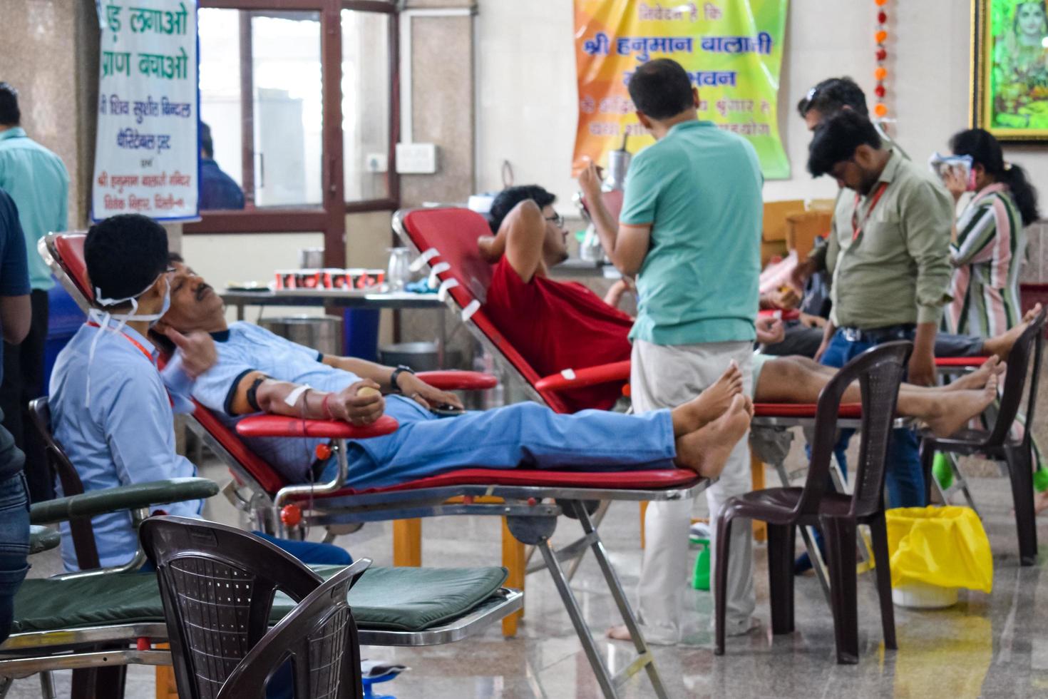 Delhi, India, June 19 2022 - Blood donor at Blood donation camp held at Balaji Temple, Vivek Vihar, Delhi, India, Image for World blood donor day on June 14 every year, Blood Donation Camp at Temple photo