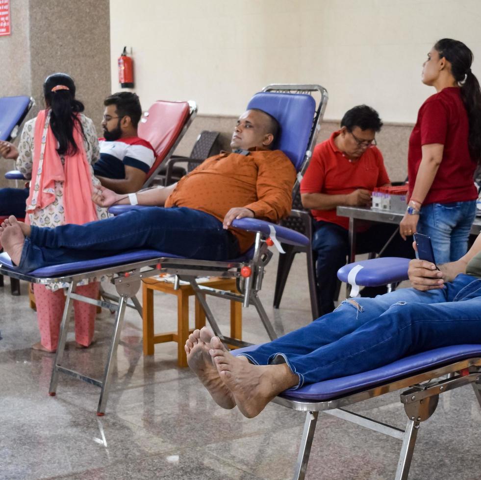 Delhi, India, June 19 2022 - Blood donor at Blood donation camp held at Balaji Temple, Vivek Vihar, Delhi, India, Image for World blood donor day on June 14 every year, Blood Donation Camp at Temple photo