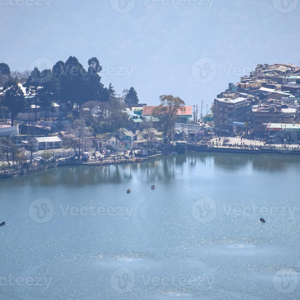 Full view of Naini Lake during evening time near Mall Road in Nainital, Uttarakhand, India, Beautiful view of Nainital Lake with mountains and blue sky photo