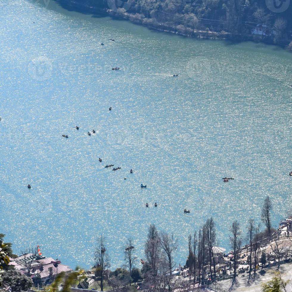 Full view of Naini Lake during evening time near Mall Road in Nainital, Uttarakhand, India, Beautiful view of Nainital Lake with mountains and blue sky photo