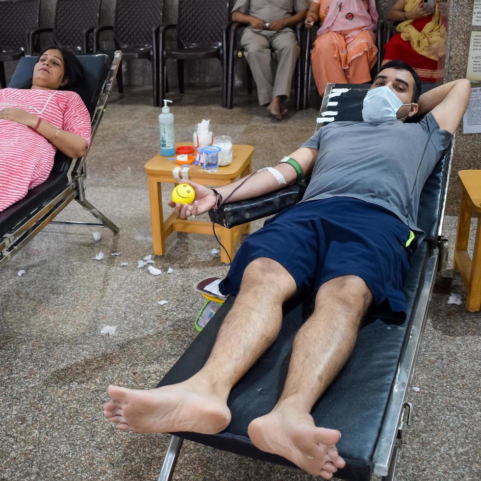 Delhi, India, June 19 2022 - Blood donor at Blood donation camp held at Balaji Temple, Vivek Vihar, Delhi, India, Image for World blood donor day on June 14 every year, Blood Donation Camp at Temple photo