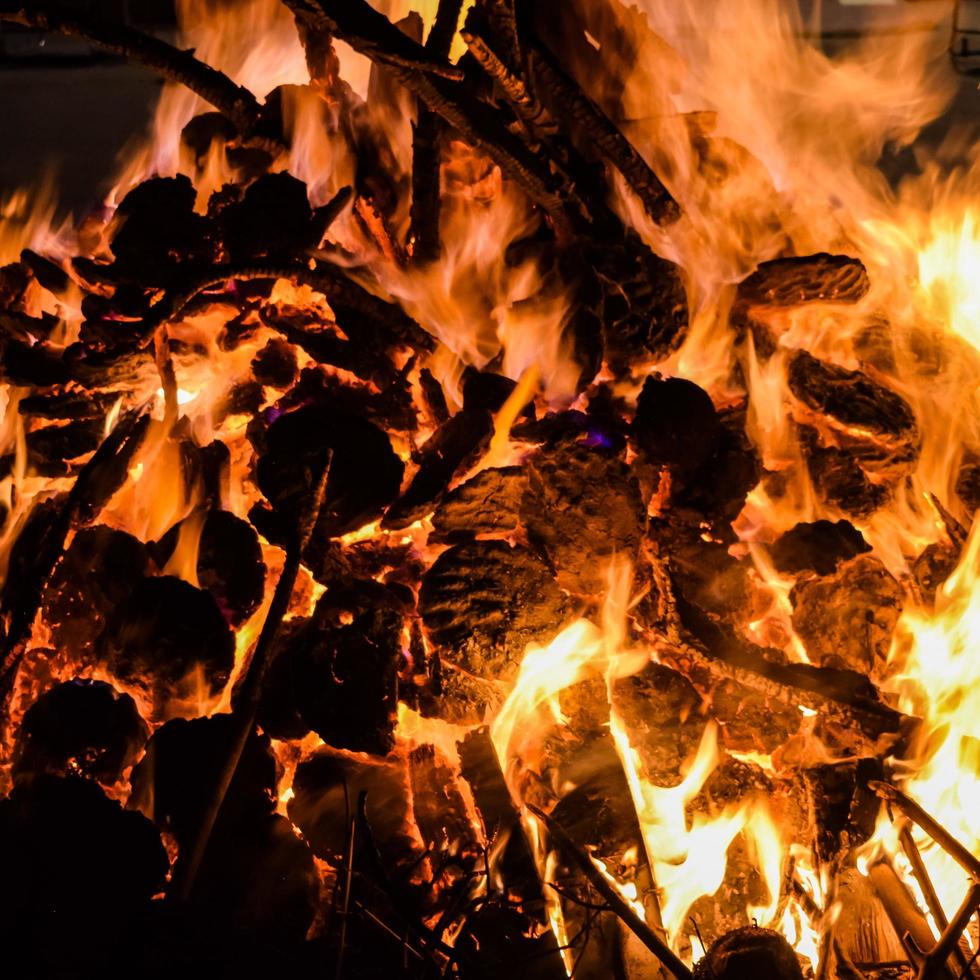 Fire flames on black background, Blaze fire flame texture background, Beautifully, the fire is burning, Fire flames with wood and cow dung bonfire photo