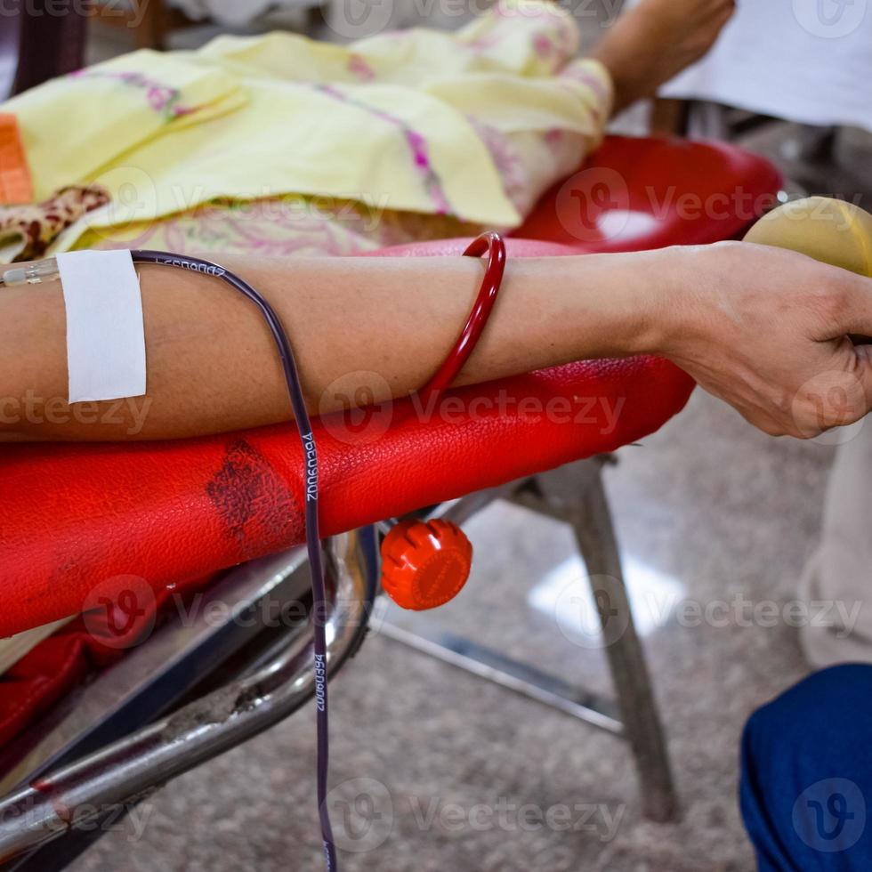 Blood donor at Blood donation camp held with a bouncy ball holding in hand at Balaji Temple, Vivek Vihar, Delhi, India, Image for World blood donor day on June 14 every year, Blood Donation Camp photo