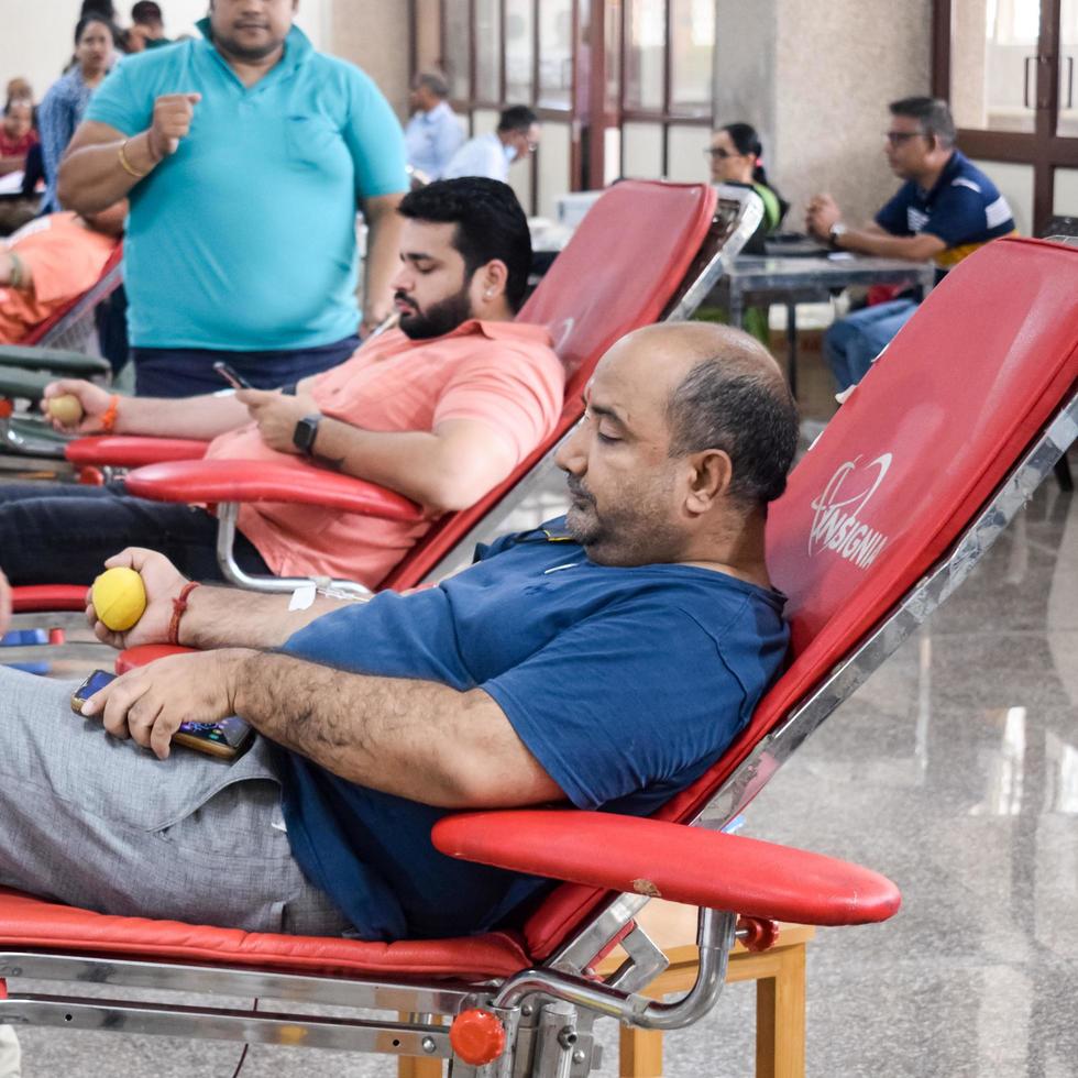 Delhi, India, June 19 2022 - Blood donor at Blood donation camp held at Balaji Temple, Vivek Vihar, Delhi, India, Image for World blood donor day on June 14 every year, Blood Donation Camp at Temple photo