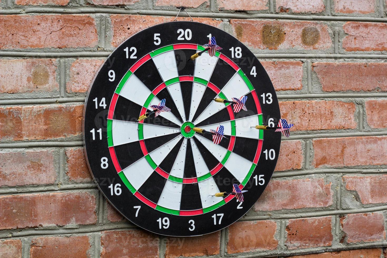 dart in bullseye on the target with many other Darts photo