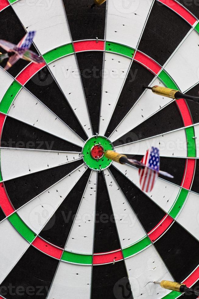 dart in bullseye on the target with many other Darts photo