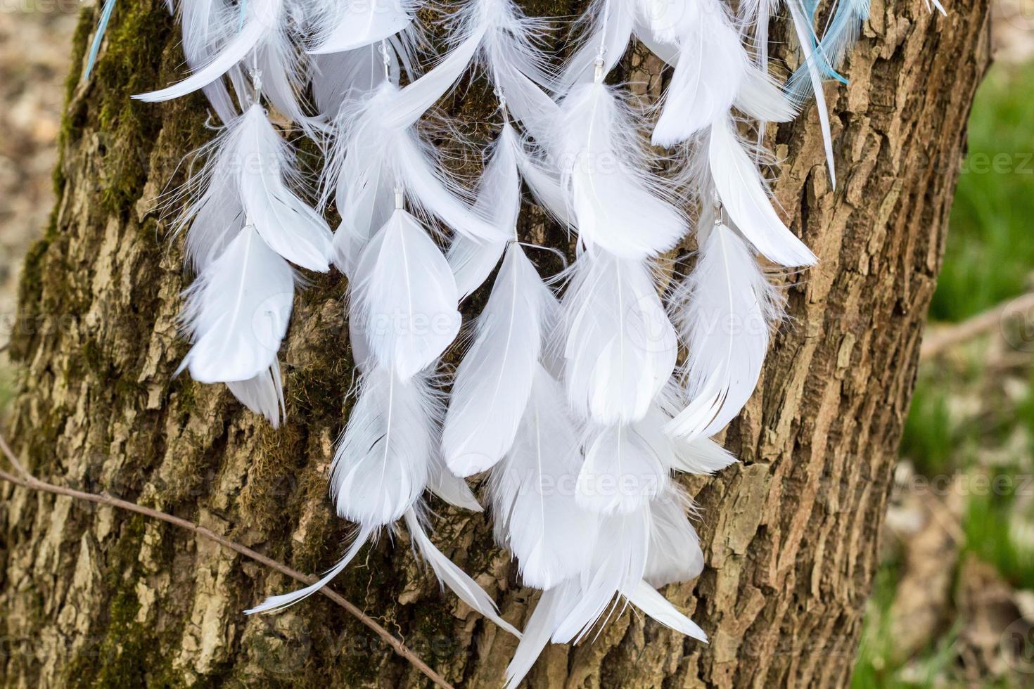 Handmade dream catcher with feathers threads and beads rope hanging photo