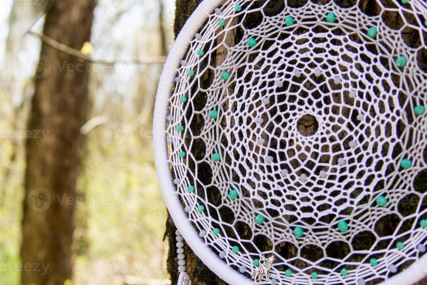 Handmade dream catcher with feathers threads and beads rope hanging photo