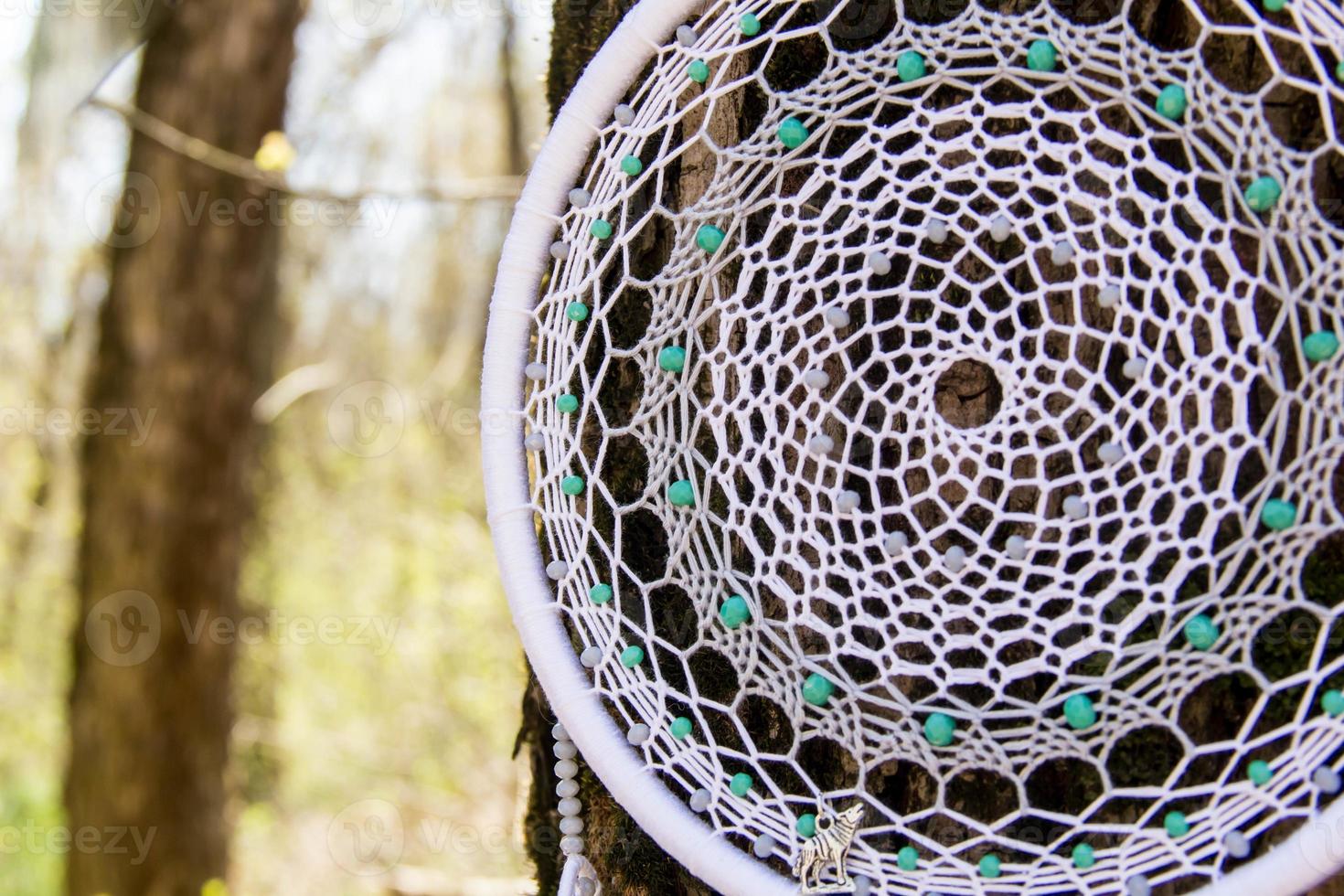 Handmade dream catcher with feathers threads and beads rope hanging photo