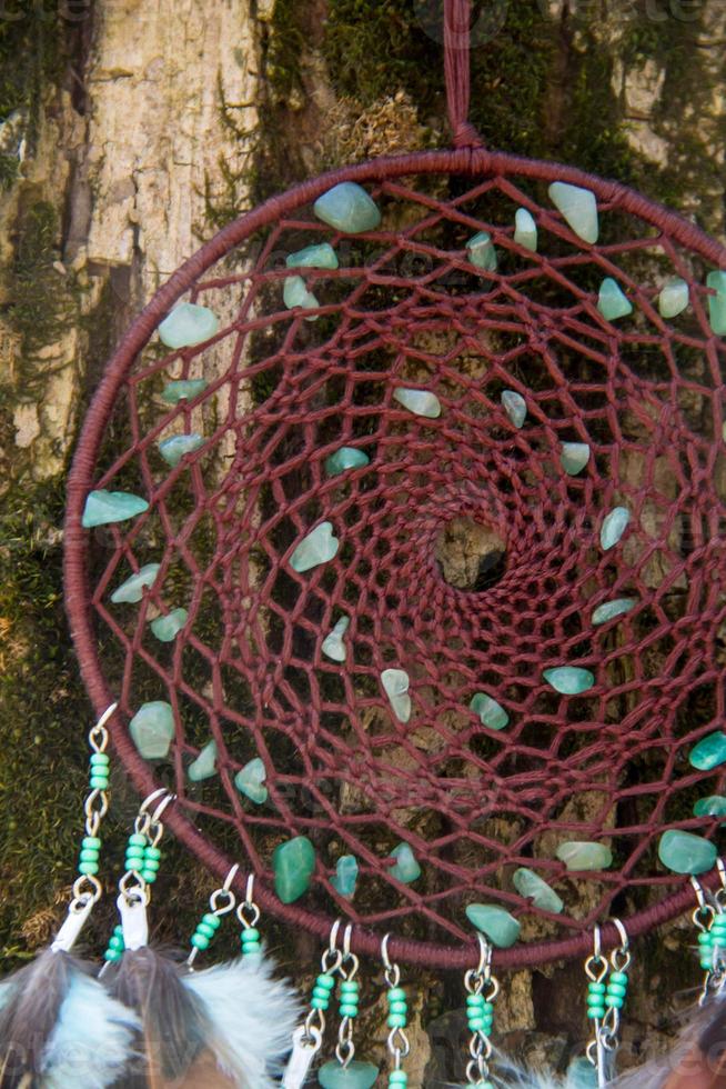 Handmade dream catcher with feathers threads and beads rope hanging photo