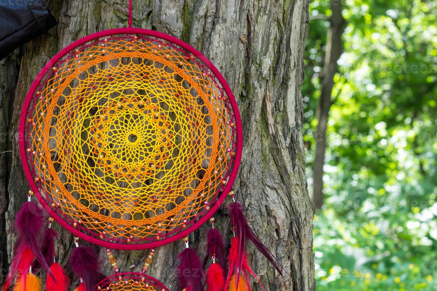 Handmade dream catcher with feathers threads and beads rope hanging photo