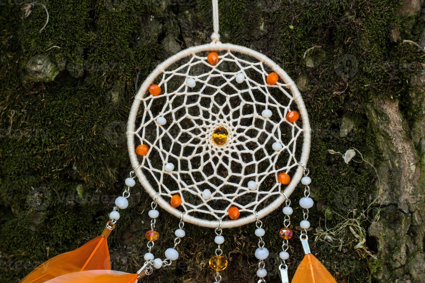 Handmade dream catcher with feathers threads and beads rope hanging photo