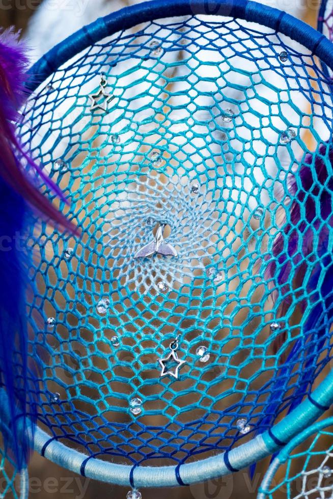 Handmade dream catcher with feathers threads and beads rope hanging photo