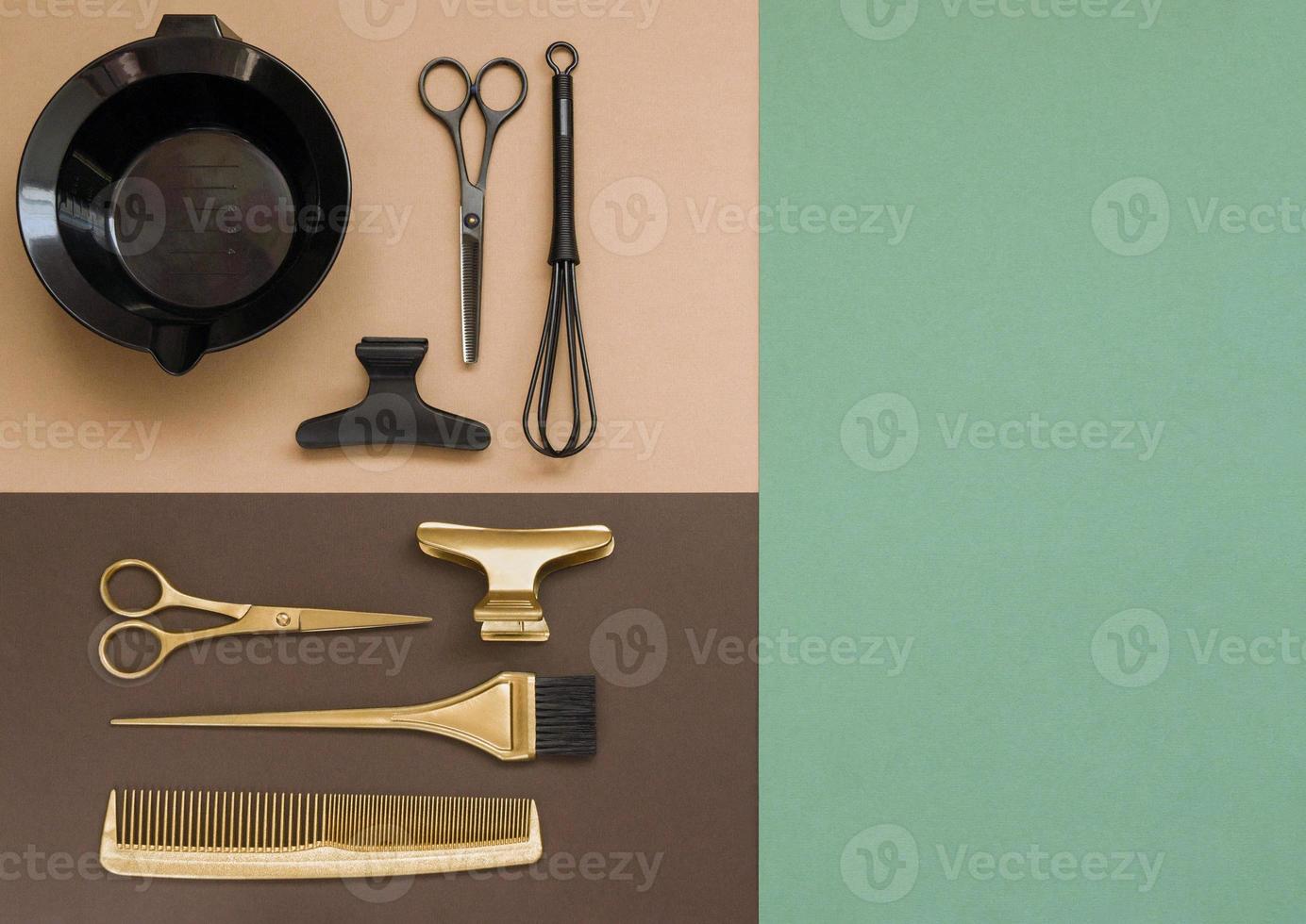 Hairdressing tools on beige, brown background and green sheet with space for text.Gold and black accessories for the hair salon, comb, brush, scissors. photo